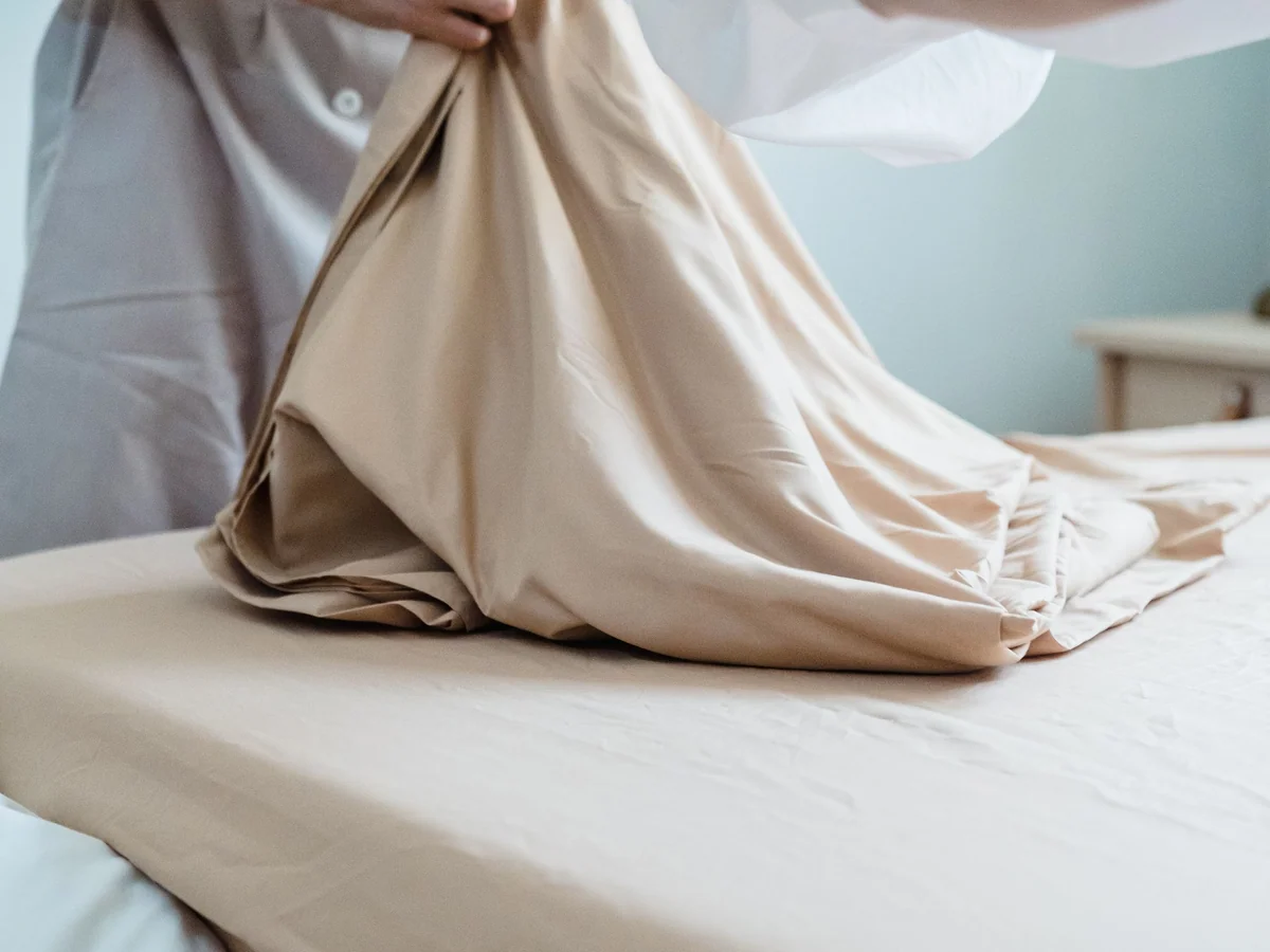 Woman preparing a comfortable guest room before extended family arrives