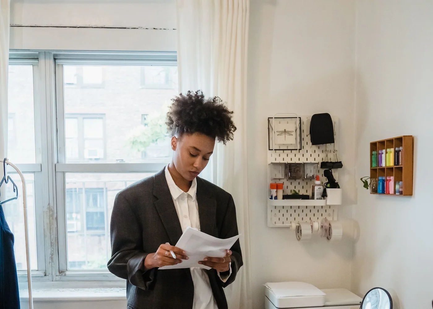 Woman reviewing work and budget notes at a bright city desk